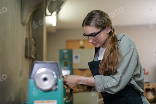 Preview: Small business of a young woman in furniture workshop background.