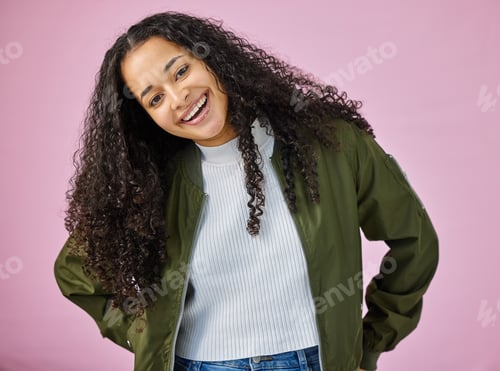 Preview: Shot of an attractive young woman standing alone against a pink background in the studio