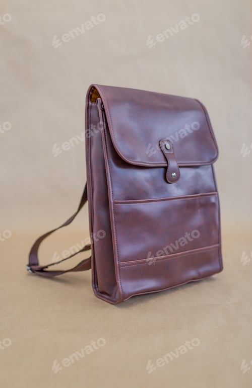 Preview: Brown leather backpacks isolated on beige background