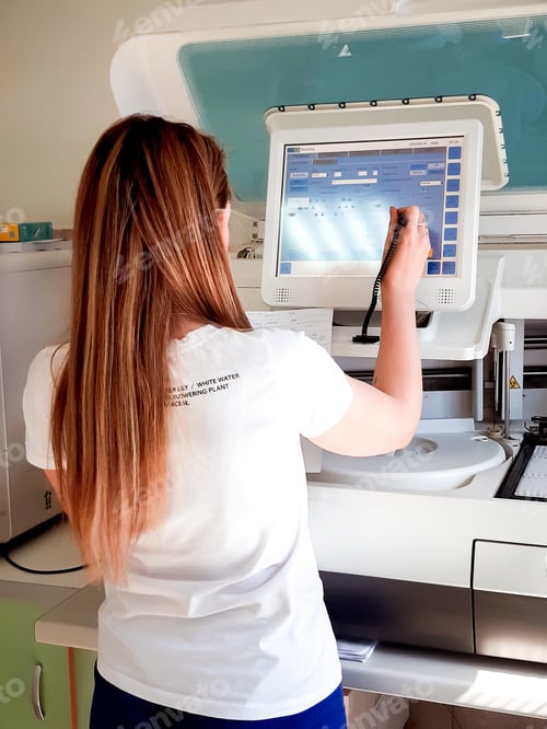 Preview: Using technology. Biochemist adjusts the parameters on the display to check the laboratory analyzes.