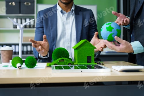 Preview: A meeting at an office desk focuses on teamwork with a house model and discussions on electric cars