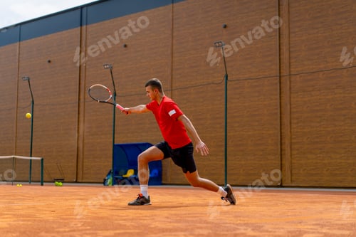 Preview: young professional player coach on outdoor tennis court practicing strokes with racket