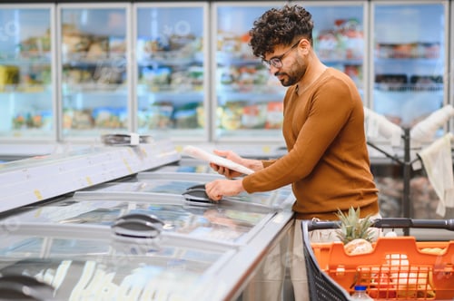 Preview: Customer choosing frozen food in supermarket refrigerator section