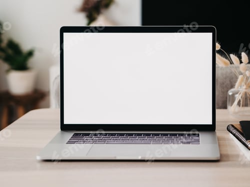 Preview: Laptop with blank screen on wooden table in home interior.