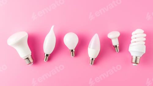 Preview: top view of various types of lamps on pink, energy concept