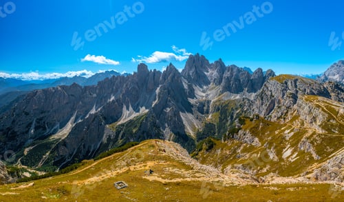 Preview: Majestic Rocky Peaks Embraced by Blue Sky and White Clouds near the Three Peaks of Lavaredo