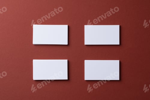 Preview: Blank white business cards on burgundy paper background