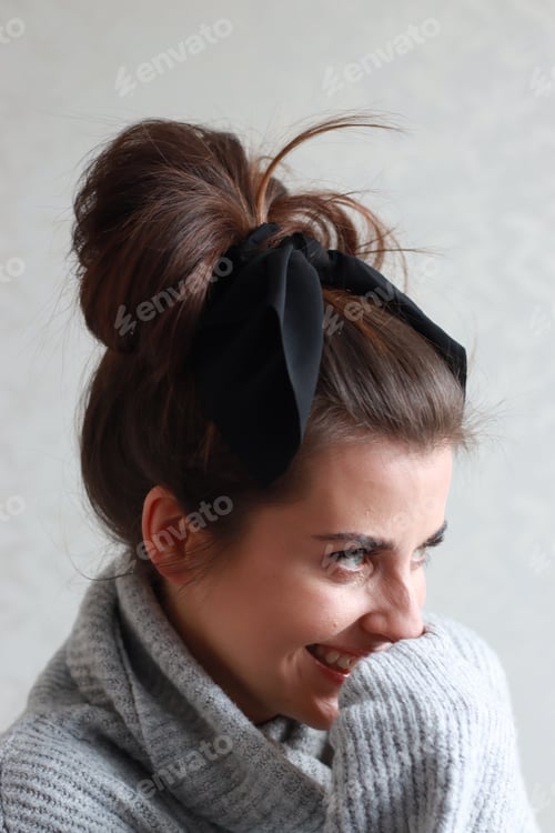 Preview: Smiling Woman Wearing Hair Ribbon and Gray Sweater