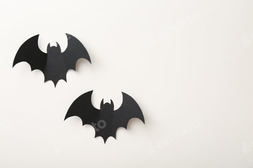 Preview: Halloween decor. Black paper bats on white background, flat lay. Space for text