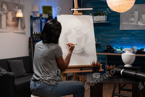 Preview: Professional female artist finishing pencil drawing