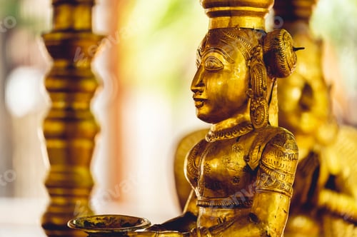 Preview: Closeup shot of Hinduism god statues covered by gold found in Hindu temples