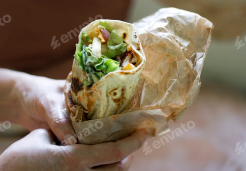 Preview: Hands holding a tortilla fast food