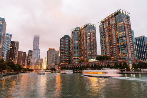 Preview: Chicago River cityscape with boats and reflections at dusk