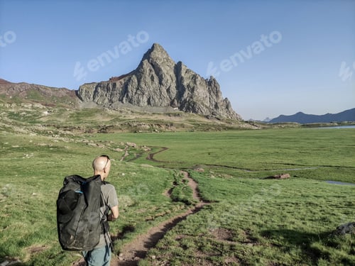 Preview: view from behind of a guy looking at his next climb