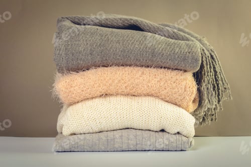 Preview: Stack of cozy knitted sweaters