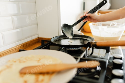 Preview: Child making pancakes for breakfast. Real people home life