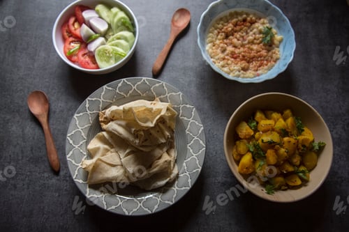Preview: Rumali roti or Indian bread and alu jeera or potato masala served