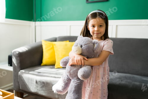 Preview: Beautiful girl hugging a stuffed toy