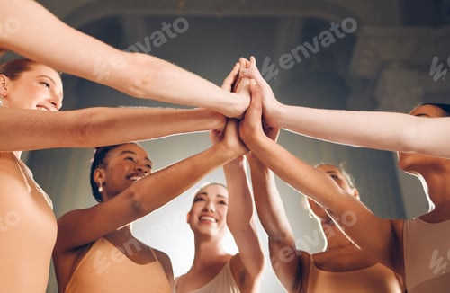 Preview: Dance lives on. Shot of a group of ballet dancers giving each other high fives.