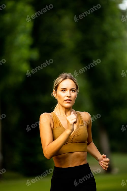 Preview: Pretty young woman running in the park