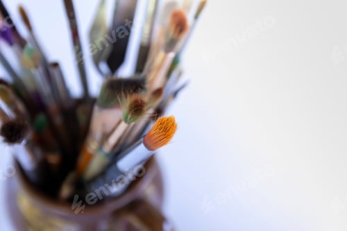 Preview: Assorted Paintbrushes in a Container on White Background