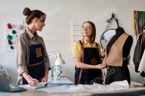Preview: Two creative female tanners in workwear consulting about new apparel model