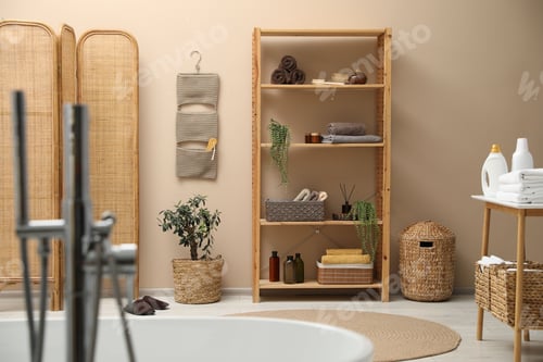 Preview: Shelving unit with soft towels, plants and bottles indoors