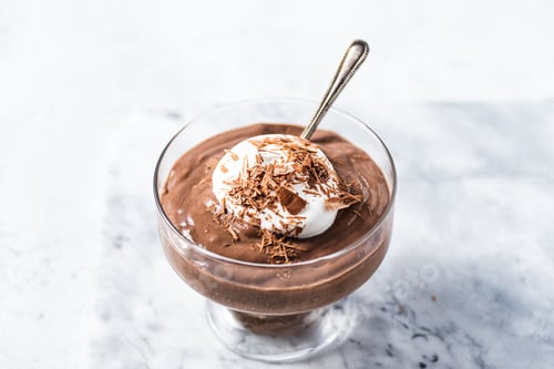 Preview: Closeup of a glass of chocolate mousse with whipped cream and grated dark chocolate