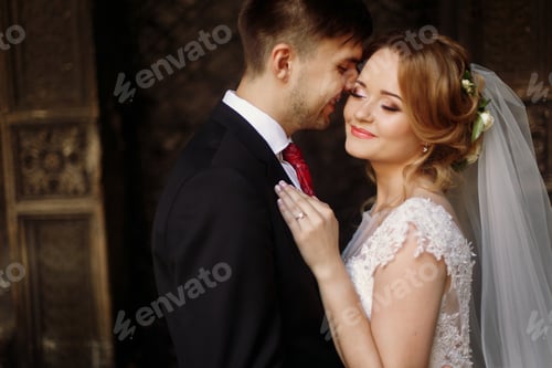 Preview: elegant wedding couple posing in old courtyard in european street