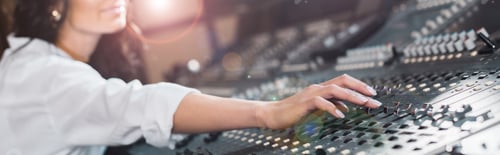 Preview: panoramic shot of sound producer working at mixing console