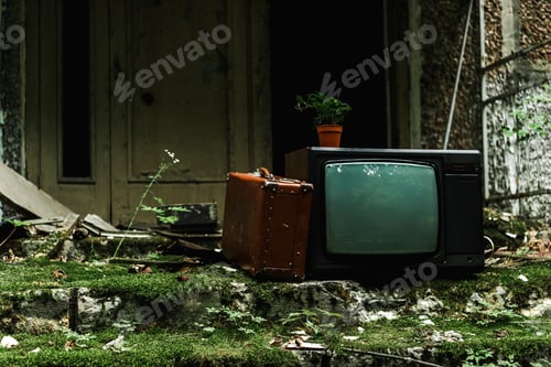 Preview: retro tv near vintage suitcase on green stairs with mold