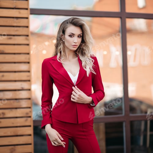 Preview: Stylish Woman in Red Suit Posing Outdoors