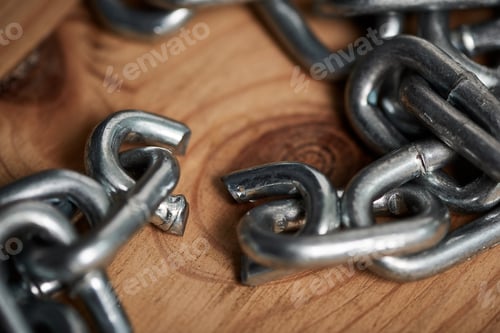 Preview: Sometimes you just have to let go. Shot of metal chains with a broken link.