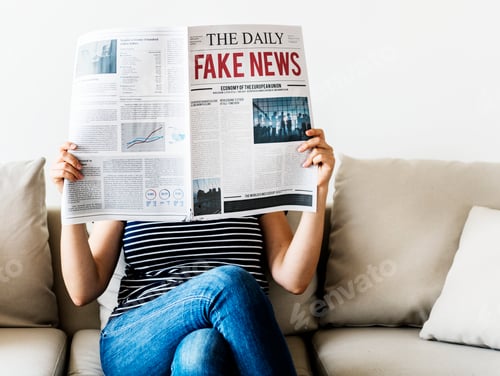 Preview: Woman reading newspaper