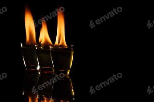 Preview: Three lit candles with copy space on black background