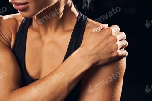 Preview: Young female athlete is experiencing shoulder cramps