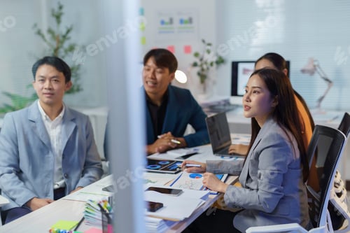 Preview: Asian businesspeople attending a meeting in the office
