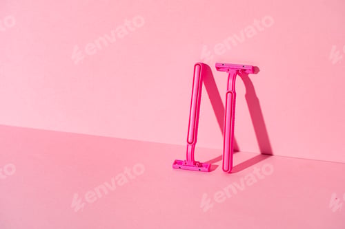 Preview: Pink disposable razors on pink background, copy space