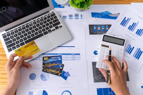 Preview: Businesswoman uses a laptop for a marketing project while analyzing company turnover using a laptop