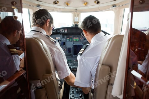 Preview: Pilot And Copilot In Cockpit Of Corporate Jet