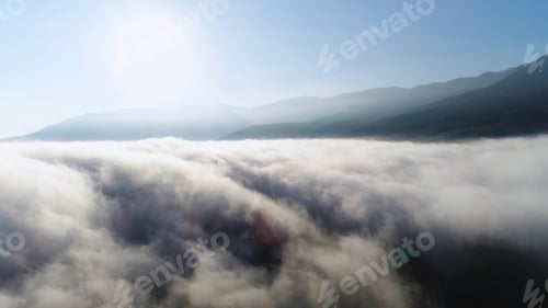 Preview: Beautiful sunrise above the clouds, view from the top of the mountain. Shot. Aerial for slow