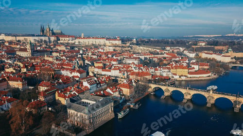 Preview: Aerial view of Prague showcasing historical architecture and the Vltava River on a clear sunny day