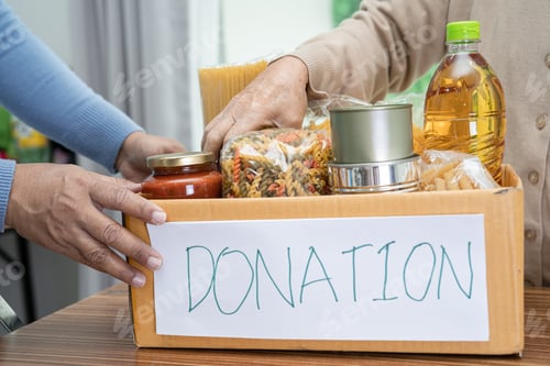 Preview: Volunteers putting various dry food in donation box for help people.