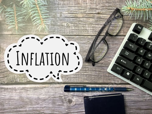 Preview: Inflation inscription with calculator, spectacles, note book and pen.