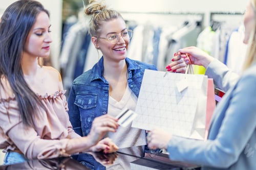 Preview: Picture of group of happy friends shopping for clothes in mall