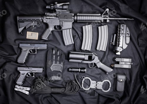 Preview: Collection of firearms and tactical gear arranged on a black surface at a certain time