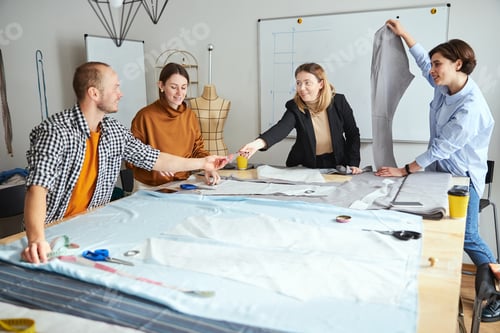 Preview: Male student passing triangle ruler to fashion teacher