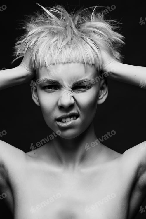 Preview: Close up on face of crazy mad cocky young woman with stylish dyed pink hair, hands ruffle her
