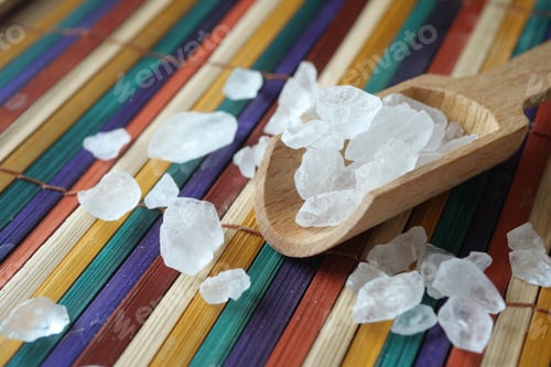 Preview: Coarse Sea Salt arrayed beautifully on a vibrant and colorful Bamboo Mat surface