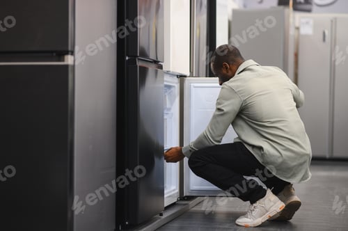 Preview: Customer choosing refrigerator in electronics store appliance department